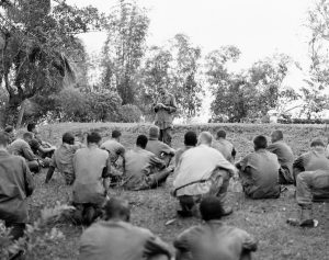 Father Vincent R. Capodanno praying with Marines in Vietnam