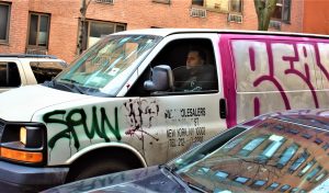 Real New Yorker near a parked car in Manhattan