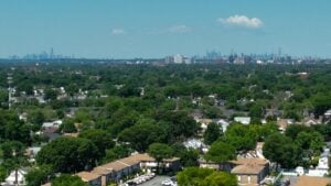 Residential neighborhoods and green acreage with the Manhattan skyline in the distance