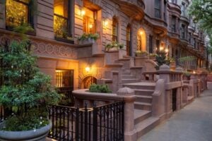 Historic New York City brownstone row houses with high stoops and carved sandstone facades