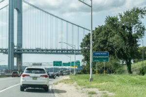 Leaving Brooklyn Fuhgeddaboudit sign beside the roadway in New York City