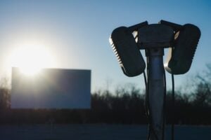 Vintage drive-in movie theater speaker with outdoor movie screen