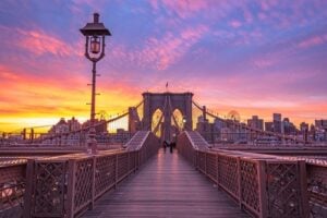 Brooklyn Bridge pedestrian walkway at sunset, one of the most romantic spots in New York City
