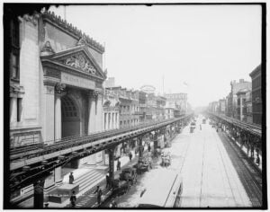 The Bowery in New York City around 1905 with the elevated railroad above street traffic