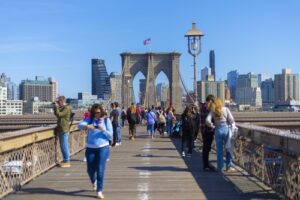 Pedestrians walking across the Brooklyn Bridge in New York City
