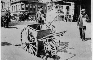 New York City White Wings street sweeper with handcart in 1896