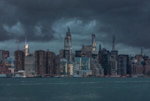 Dark storm clouds over the New York City skyline representing the Gotham nickname