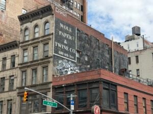 Wolf Paper and Twine ghost sign on Sixth Avenue in Chelsea