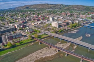 Aerial view of downtown Elmira, New York, along the Chemung River with bridges and surrounding hills