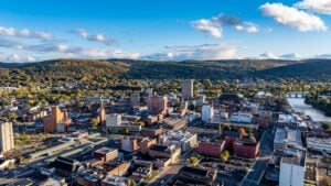 Aerial view of downtown Binghamton, New York, with surrounding hills and the Southern Tier landscape.