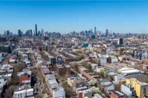 Aerial view of Brooklyn neighborhoods with the Manhattan skyline in the distance
