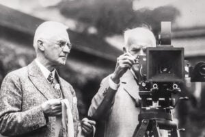 George Eastman and Thomas Edison examining a motion-picture camera at Eastman's home in Rochester, New York, in 1928.