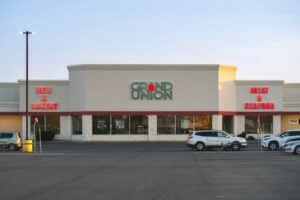 Grand Union supermarket storefront in Rome, New York, displaying the chain's distinctive red-dot logo