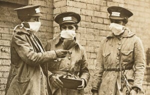 Three New York City streetcar conductors wearing protective masks during the 1918 influenza epidemic