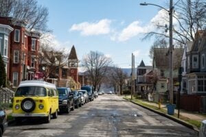 Residential street on Courtney Avenue in Newburgh, New York, with historic houses and parked cars