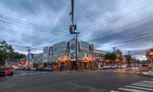 Street corner and shops in downtown Oyster Bay, New York, at dusk