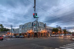 Street corner and shops in downtown Oyster Bay, New York, at dusk