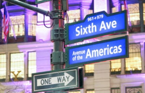 Sixth Avenue and Avenue of the Americas street signs in Manhattan, New York City
