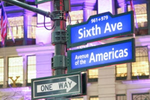 Sixth Avenue and Avenue of the Americas street signs in Manhattan, New York City