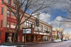 State Theatre on State Street in downtown Ithaca, New York, with its historic marquee and surrounding downtown buildings.